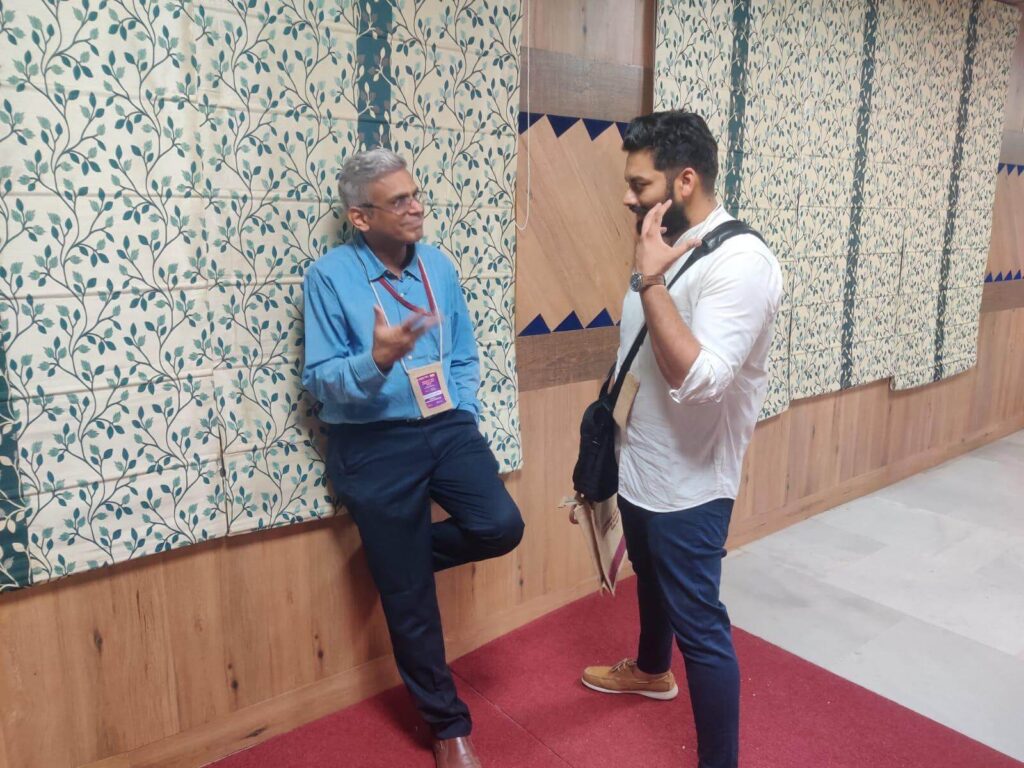 Kartheek speaking with Dr. Krishna Kumar, with Amrita Hospital, at the ACHD symposium